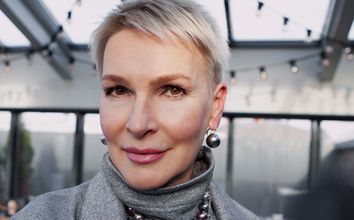 Stylish Hyperbaric Oxygen Therapy model with short hair and earrings.